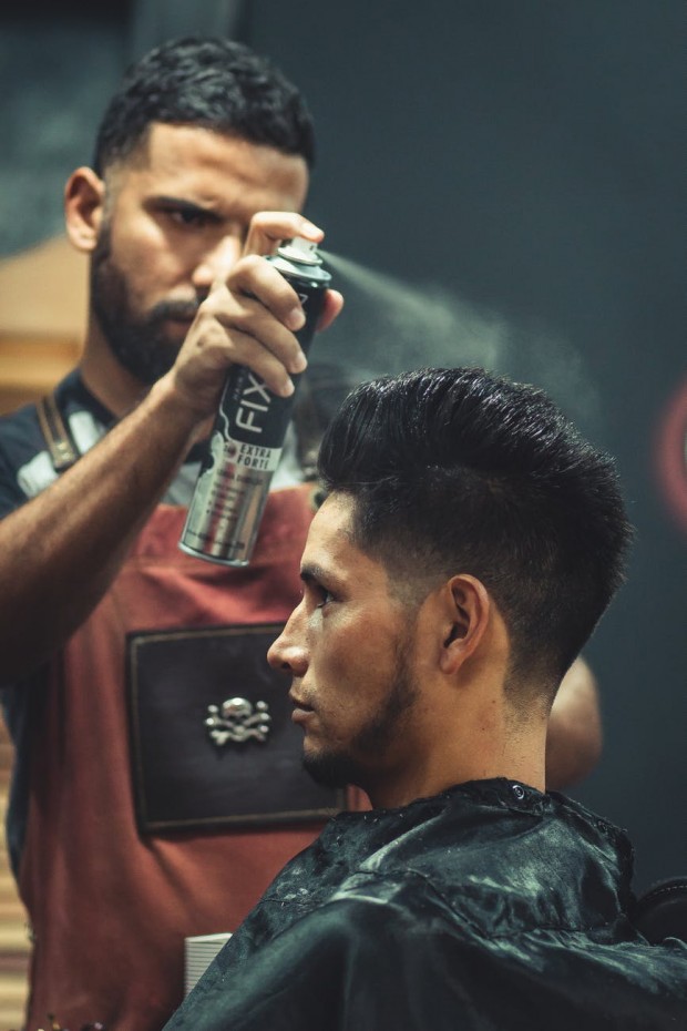 Barber using hairspray