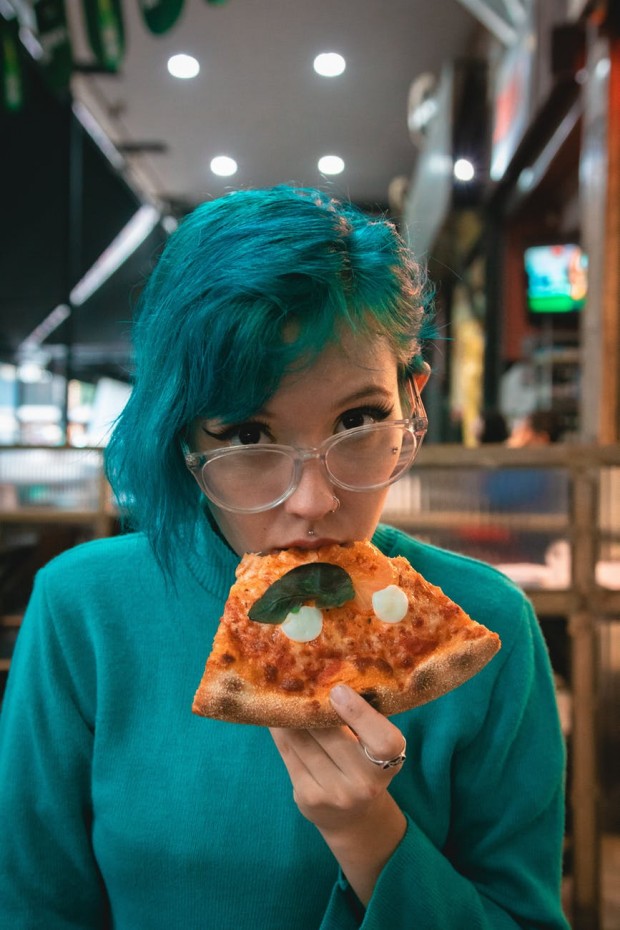 Teen eating pizza