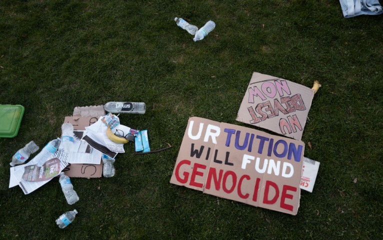 Protest signs lay in the grass on the Northwestern University campus in Evanston, Illinois, on April 25. The rally is among many roiling university campuses across the country in response to the ongoing war in Gaza. 
